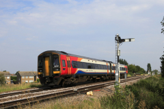 East Midlands Railway Regional train 158 857 passing a Semaphore signal, Whittlesey town, Fenland, Cambridgeshire, England
