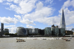 Rowing boats passing the Shard skyscraper