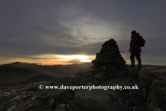 Walker at the summit cairn on Carrock fell