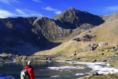 Walker at Mount Snowdon reflected in Llyn Llydaw