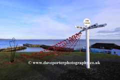 Remembrance Poppies at the Milepost at John O Groats village, North coast of Caithness, Scotland, UK
